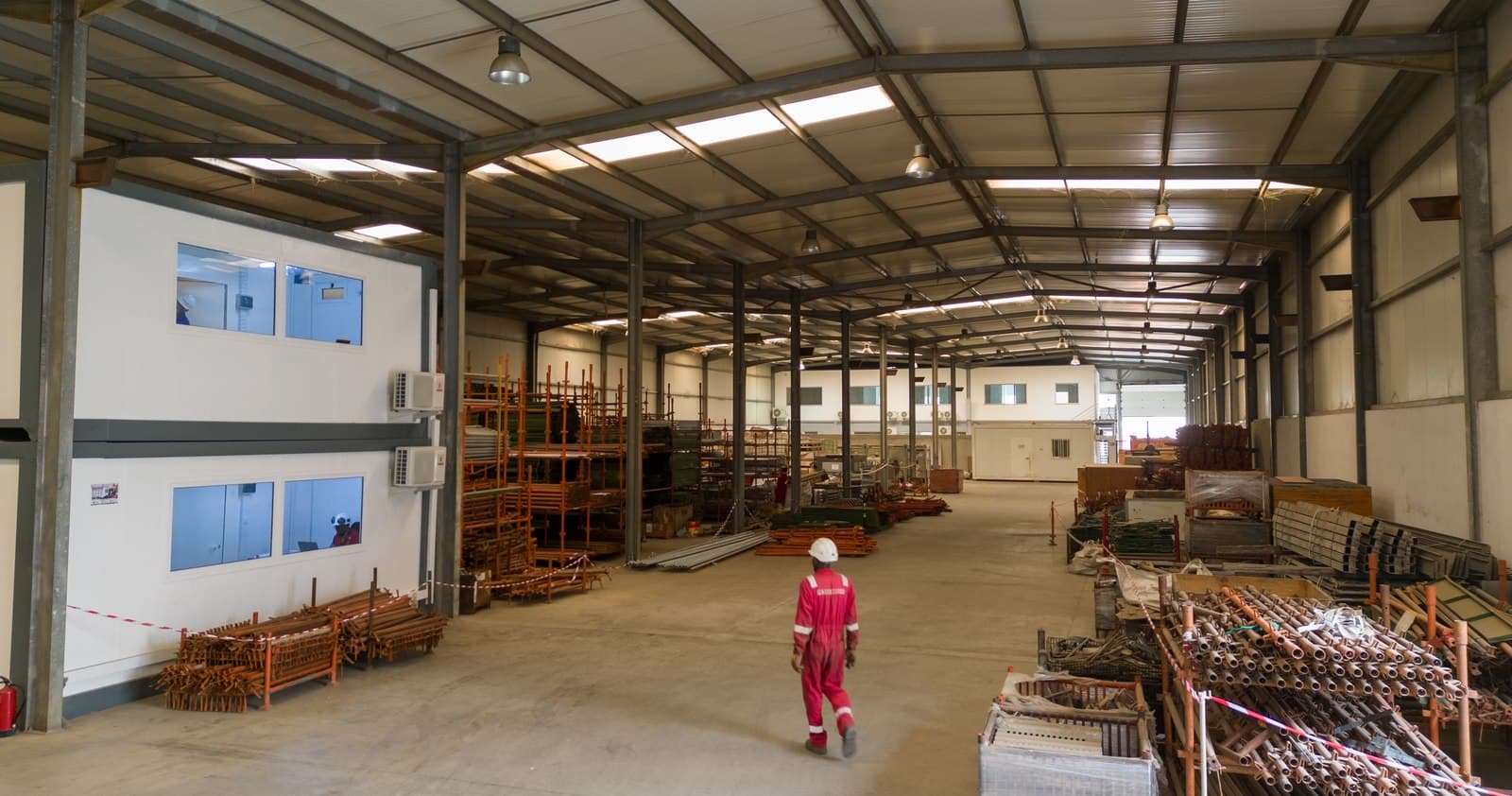 Technician walking through the Petrowork warehouse in Viana