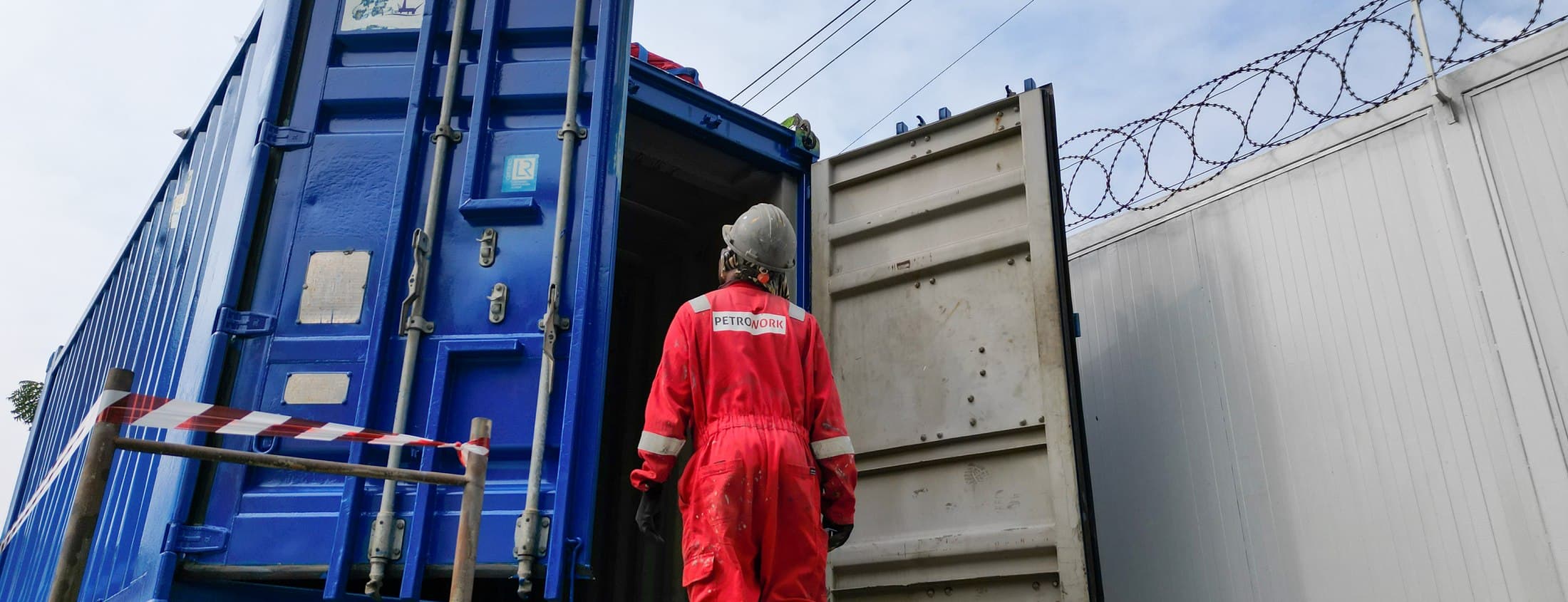 Technician heading into a container on site